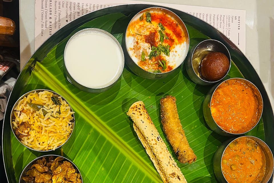 A South Indian vegetarian thali served on a banana leaf